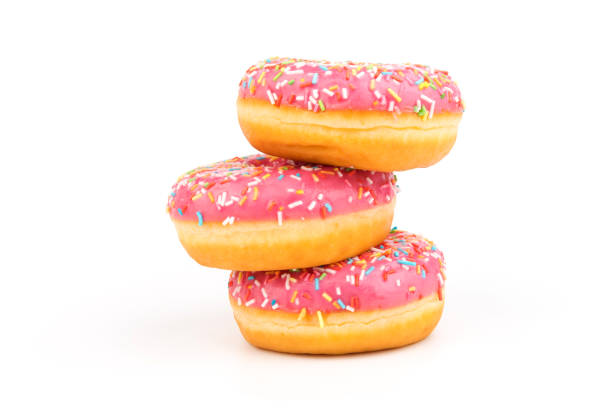 istock Fresh made Donuts isolated on white background. Doughnuts are traditional sweet pastries. Copy space for text. 1312838253