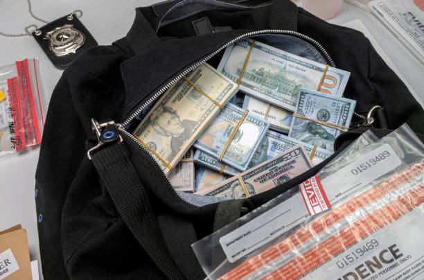 istock Black duffel bag full of dollar notes in criminal investigation unit, conceptual image 1312838559
