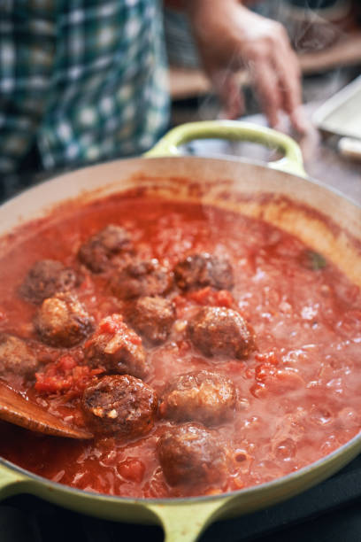 istock Preparing Meatballs with Tomato Sauce in a Pan 1312839655
