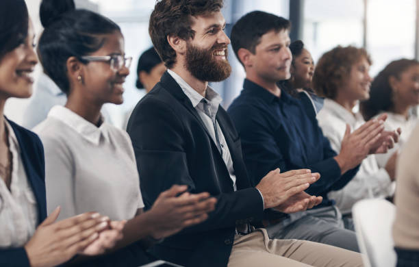 istock Shot of businesspeople clapping hands while attending a business presentation 1312840098