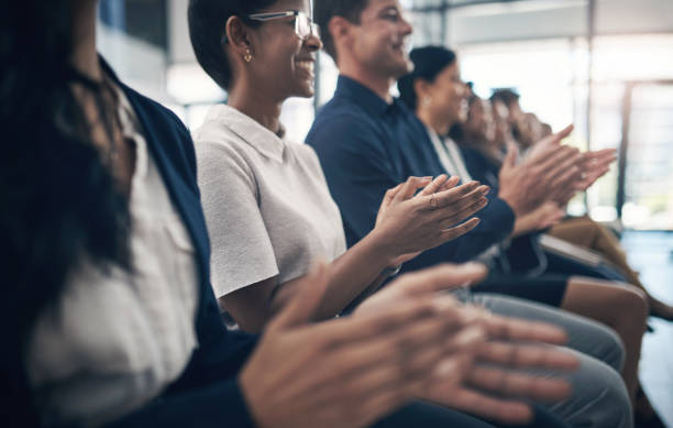 istock Shot of businesspeople clapping hands while attending a business presentation 1312840111