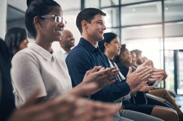 istock Shot of businesspeople clapping hands while attending a business presentation 1312840114