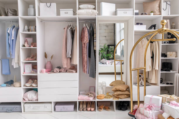 istock Modern white wardrobe with stylish spring clothes and accessories. Large wardrobe with various clothes 1312843052
