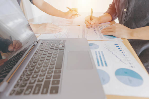 istock Business team analyzing income charts and graphs with modern laptop computer. Close up.Business analysis and strategy 1312843305