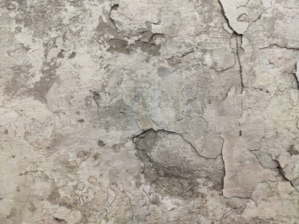 istock Grey Concrete Texture old wall with peeling paint, scratches and cracks 1312844011