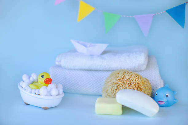 istock Yellow rubber ducky in small bath, natural sponge and soap 1312844286
