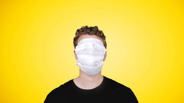 istock Man wearing emoji mask 1312844555