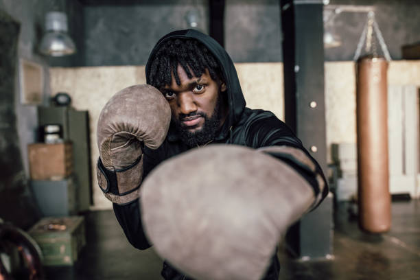 istock black boxer. Punch to the camera, close-up 1312845630