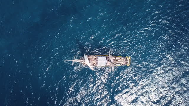 Aerial view of an ancient sailing ship over blue water