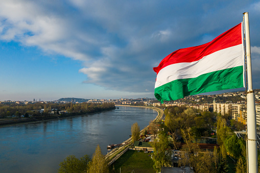 Hungarian flag waving over Budapest, the captial city. Stock photo.