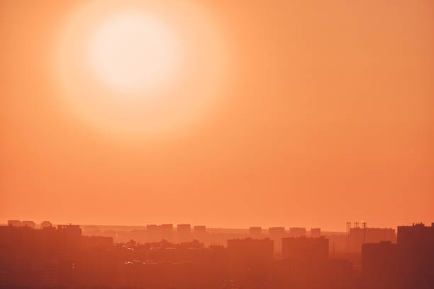 istock City buildings against an orange sunset sky, copy space 1312850712