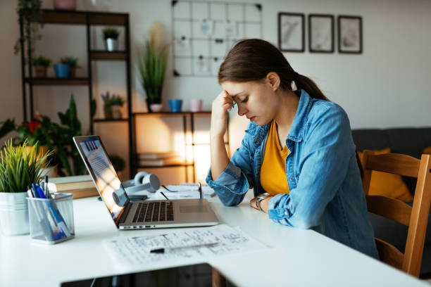 istock Stressed woman having headache while working from home during covid-19 1312853908