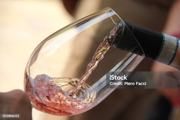 Rose Wine Being Poured Into A Glass During An Outdoor Party Stock Photo - Download Image Now