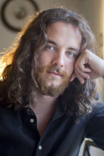 istock Man with gray eyes, beard and long brown hair 1312856811