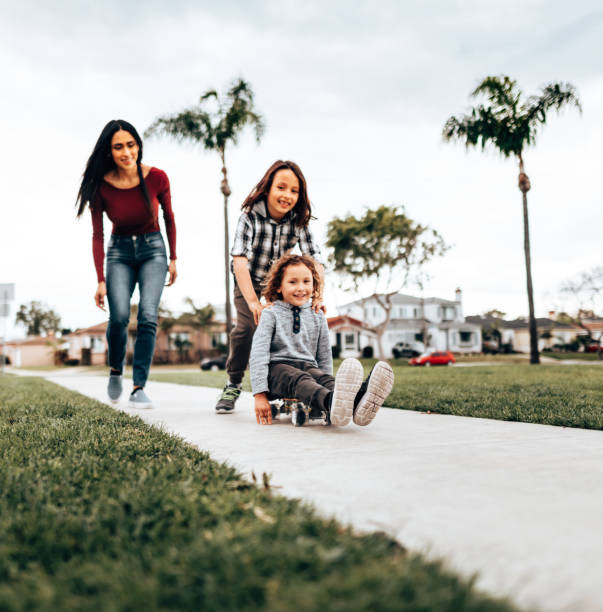 istock mother playing with sons at the park 1312857115