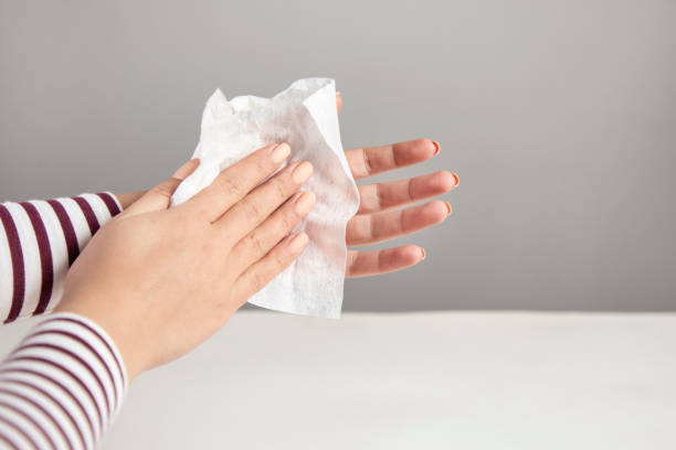 istock Woman cleaning hand with napkin 1312857697