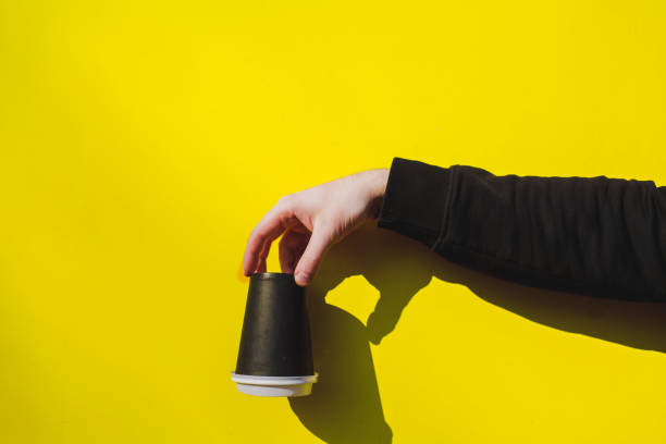 istock hand holds an upturned paper cup 1312857851