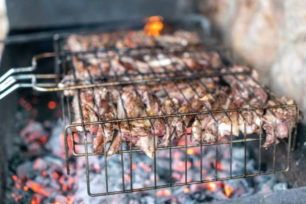 istock Lamb ribs cooked over an open fire, close-up. Lamb chops Grilling Barbecue, BBQ Originally made from lamb. Wire rack for roast lamb in the grill racks. The concept of traditional food on fire 1312859207