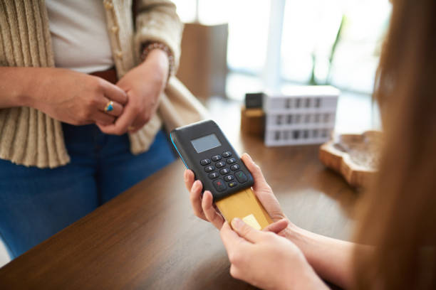istock Shot of a woman using a card machine while doing a card payment in a store 1312860883