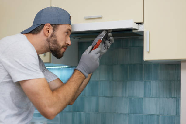 istock Fast and professional. Young handyman looking focused while fixing a kitchen extractor with a screwdriver indoors 1312862991