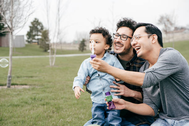 istock Two dads with toddler son outdoor with bubbles 1312865865