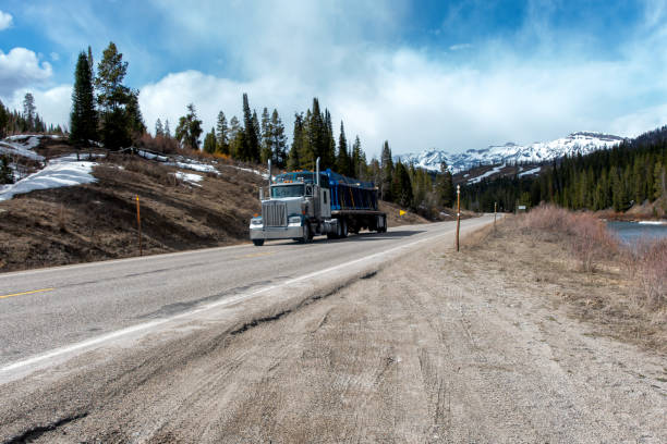 istock Long Haul Semi Trucks on A Two Way Highway 1312874114