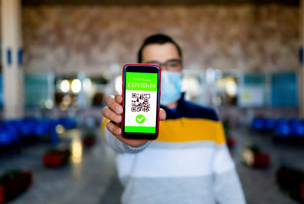 istock Man showing certificate of covid-19 vaccination 1312875673