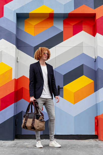 istock Young man in trendy outfit with bag 1312878633