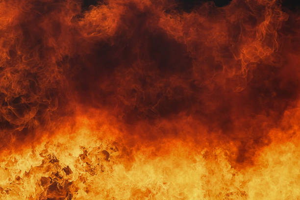 istock Fire flames texture on isolated black background. Perfect texture overlays for copy space 1312883209