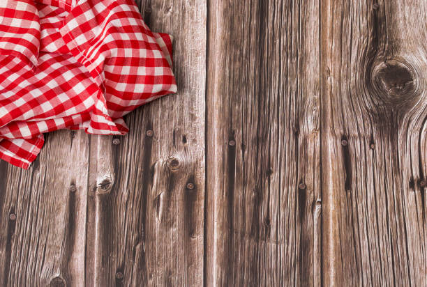 istock Rustic wooden background with red checkered napkin - Text space 1312887417