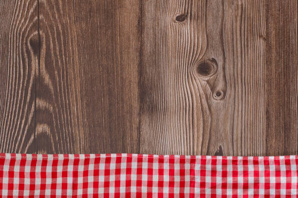 istock Rustic wooden background with red checkered napkin - Text space 1312887451