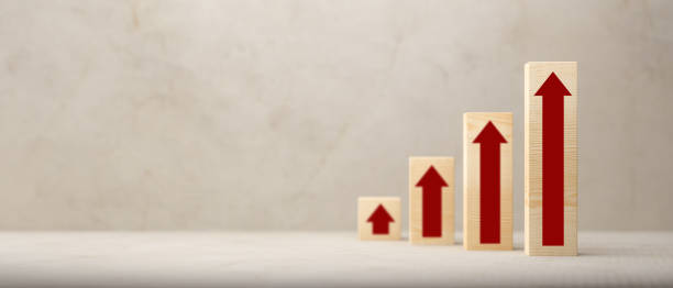 istock Ascending bar graph on wooden blocks with red arrows - 3d illustration 1312889776