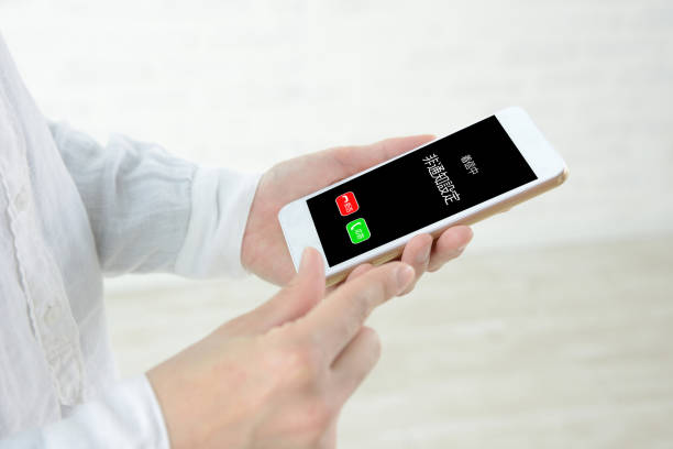 Human's hands and smart phone with unannounced call in Japanese