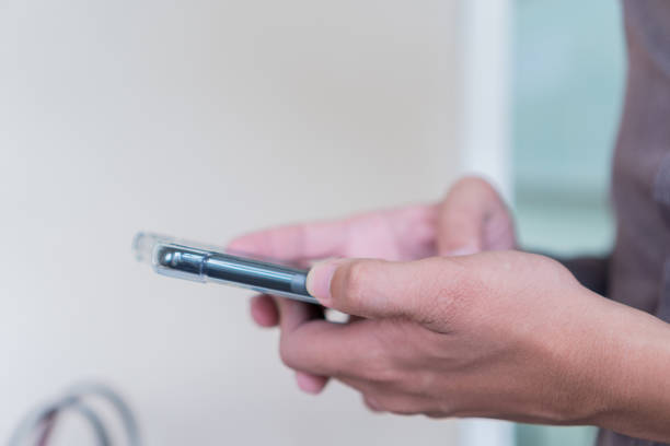 istock Online Education concept: Male student using smartphone application studying homework in online lesson from home when social distancing or quarantine, self-isolation when Covid-19 outbreak pandemic 1312895357