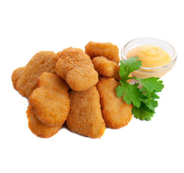 istock Chicken nuggets with herbs and cheese sauce. Close-up. Isolate. White background. 1312907811