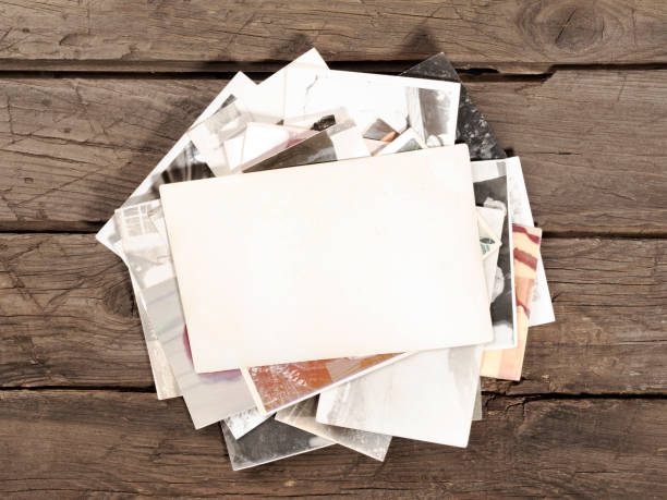 istock old retro photos with copy space on wooden background 1312912098