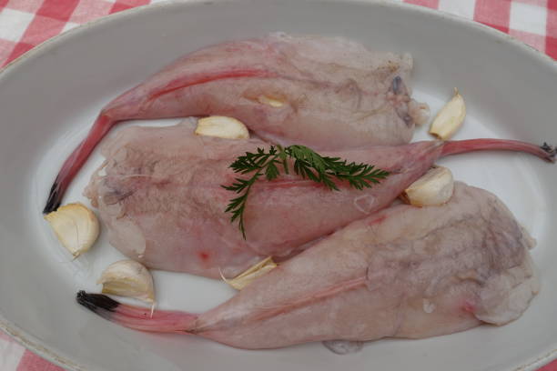 istock Monkfish tails being prepared with garlic before baking 1312912184
