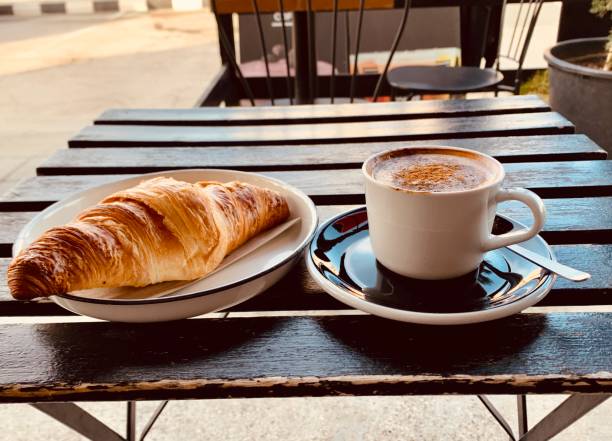 istock Cup of coffee and croissant on the table 1312912233