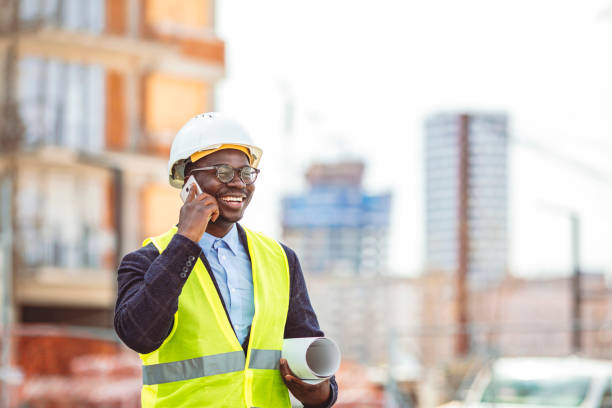 istock Confident construction manager wearing hardhat and talking with smarphone. 1312912999