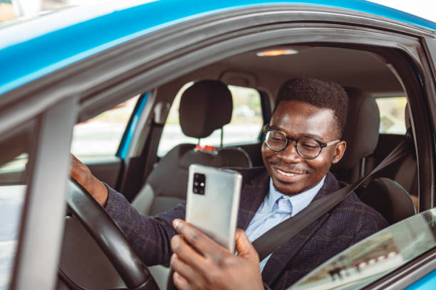 istock Cropped shot of a man using his phone while driving. 1312913875