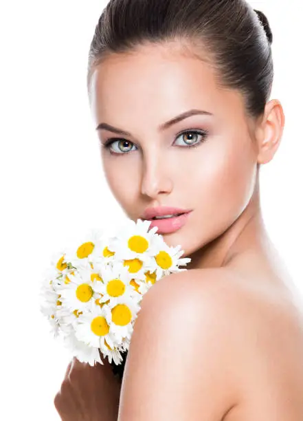 Photo of Face of young beautiful woman with posy flowers