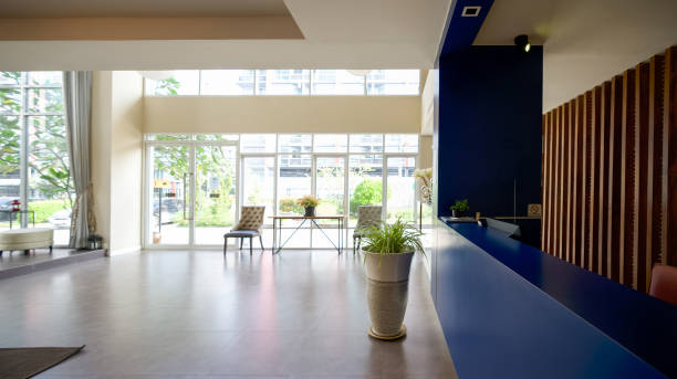 istock A long dark blue reception counter is located beside the hotel lobby. 1312915042