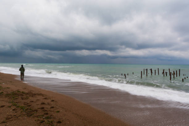 istock Man standing by the sea 1312917150