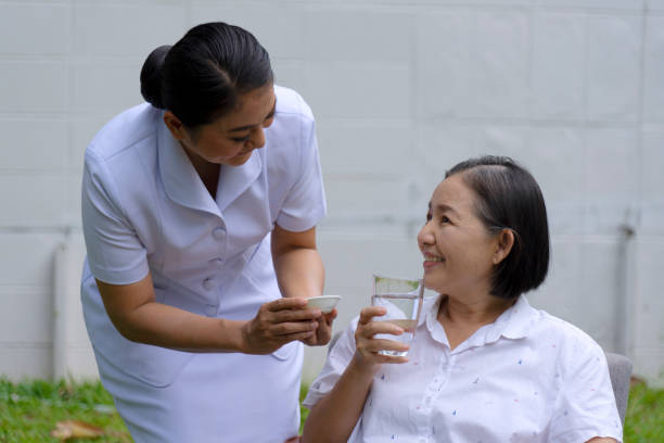 istock Senior woman with nurse. 1312919963