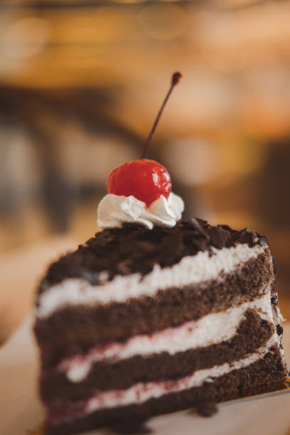 istock A slice of delicious black forest cake, garnished with chocolate and cherry 1312923788