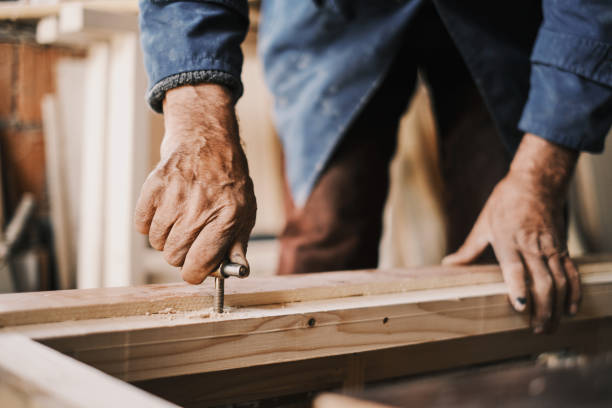 istock An old carpenter, he screws into a wood in an old workshop. 1312926920
