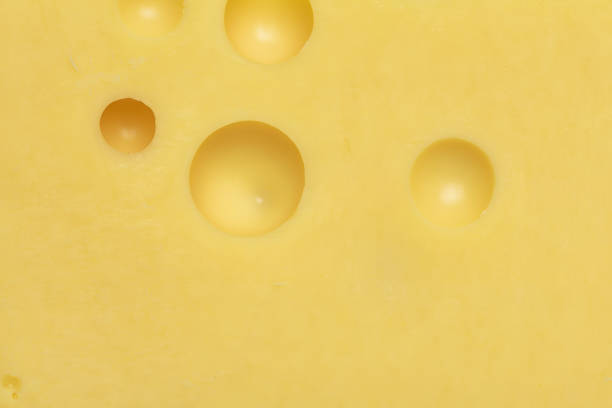 istock Cheese with holes background or texture macro shot 1312928080