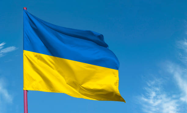 National flag of Ukraine or Ukrainian flag against blue sky National flag of Ukraine or Ukrainian flag against blue sky pole photos stock pictures, royalty-free photos & images