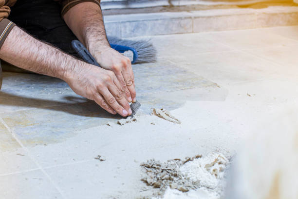 istock cleaning the floor manually with a construction trowel from adhering glue in the production workshop, the foreground and background are blurred with a bokeh effect 1312933219