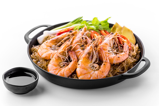 Baked shrimp with glass noodles on white background